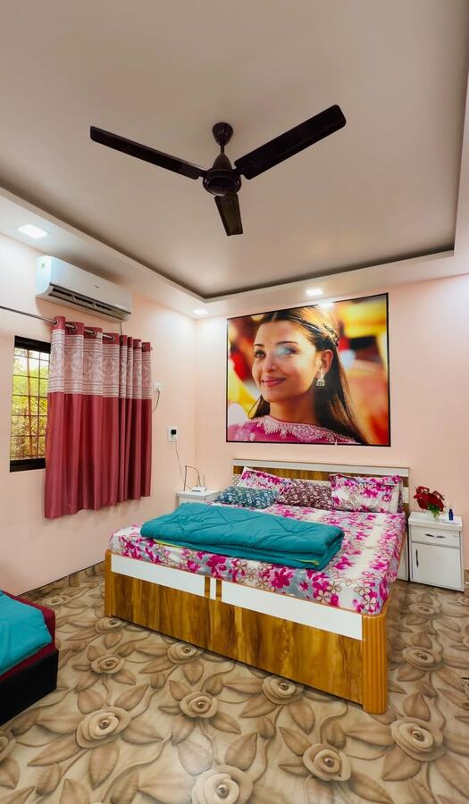 Cottage bedroom with pink walls and floral bedding