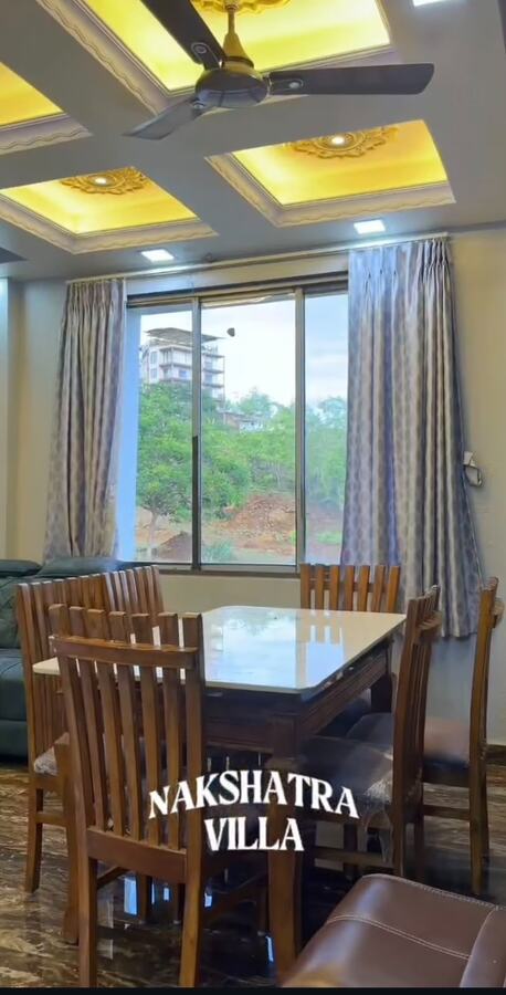 Nakshatra Villa dining area with a hillside view
