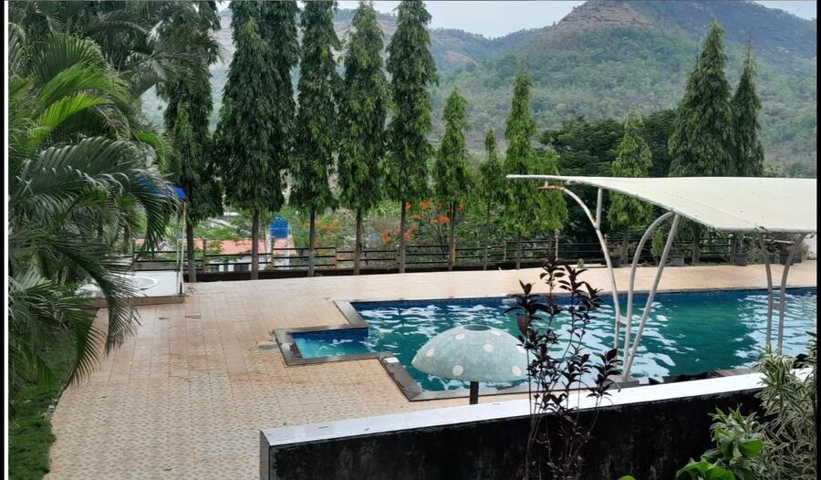 Outdoor pool with Sahyadri hill views